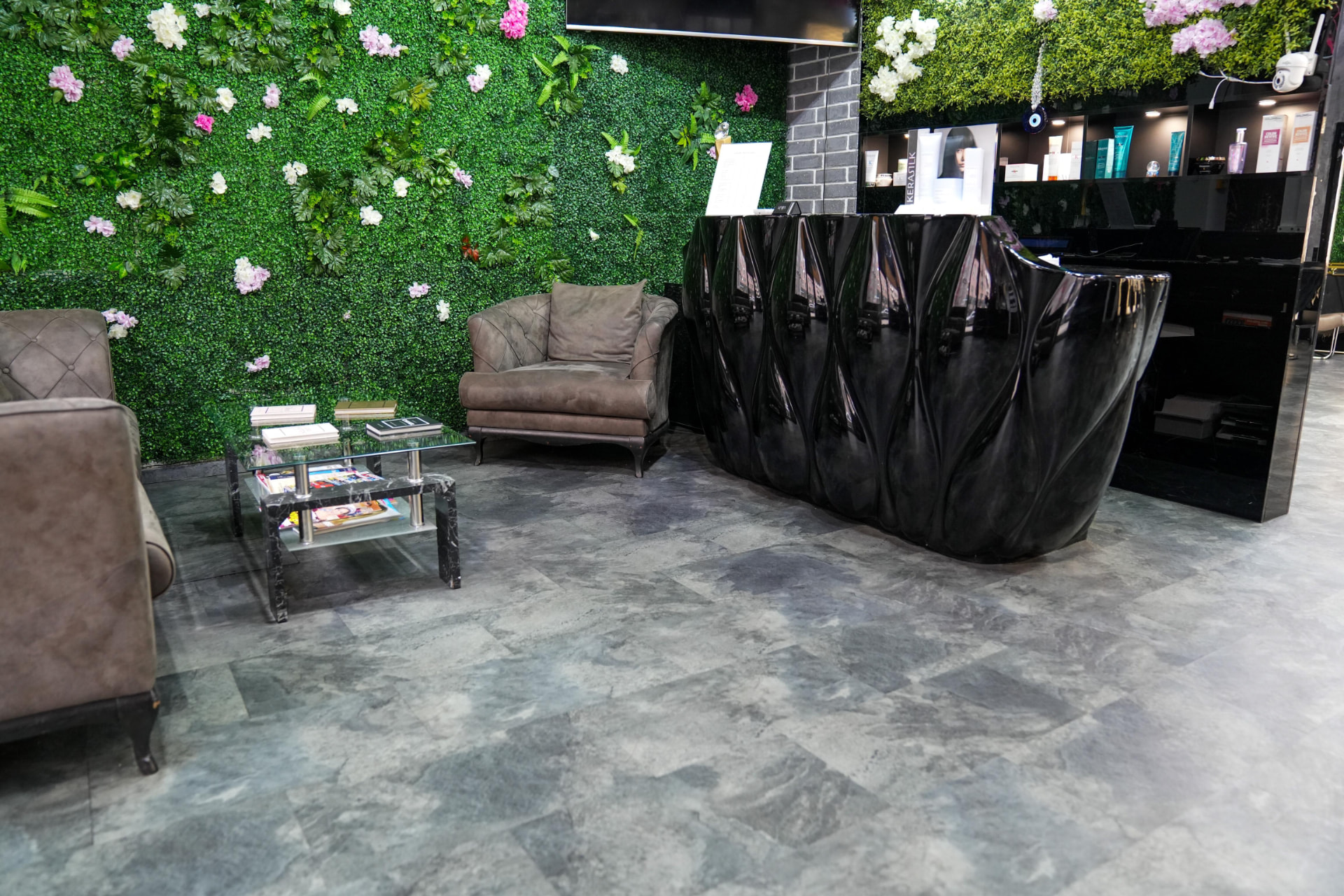 Reception mit Pflanzenwand und schwarzer Theke